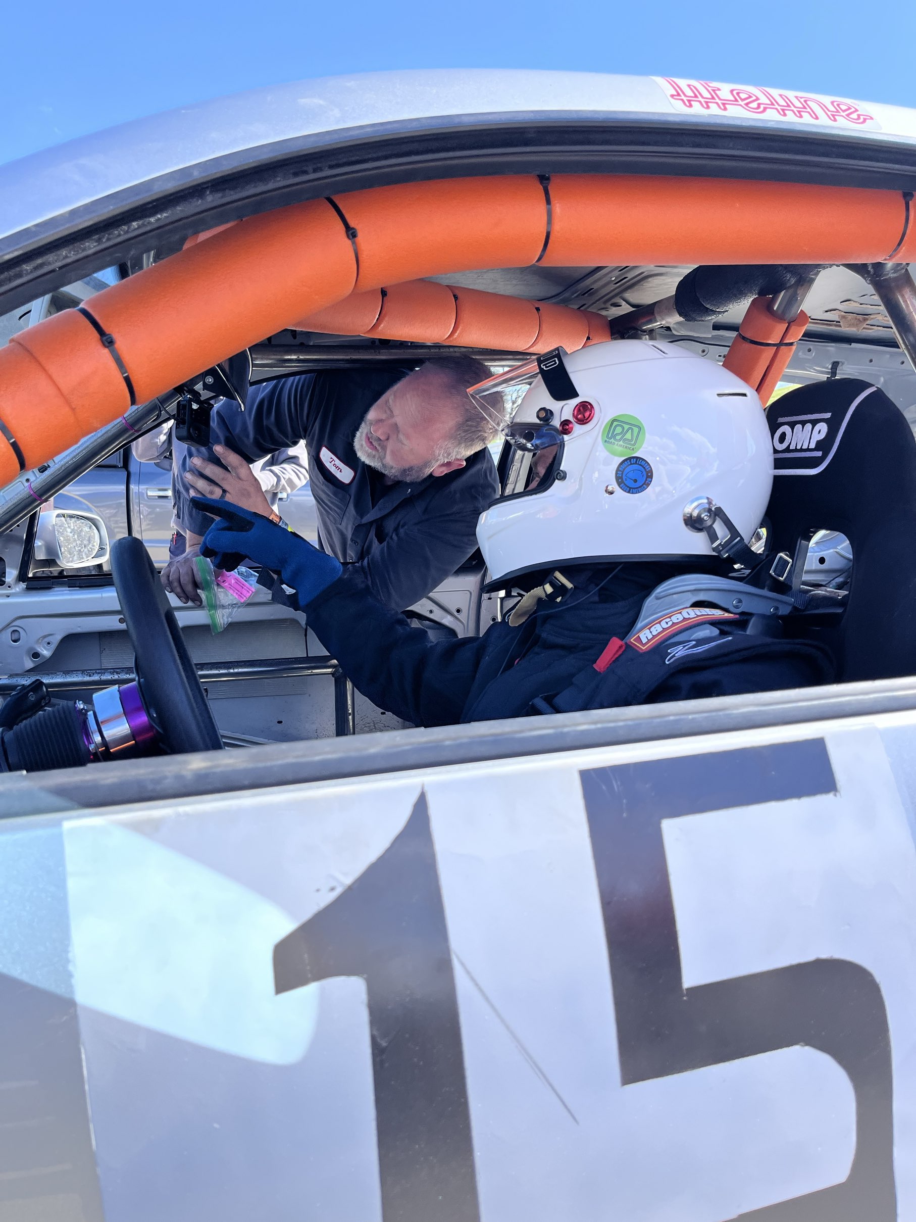Tom helping Chad get strapped in during driver change