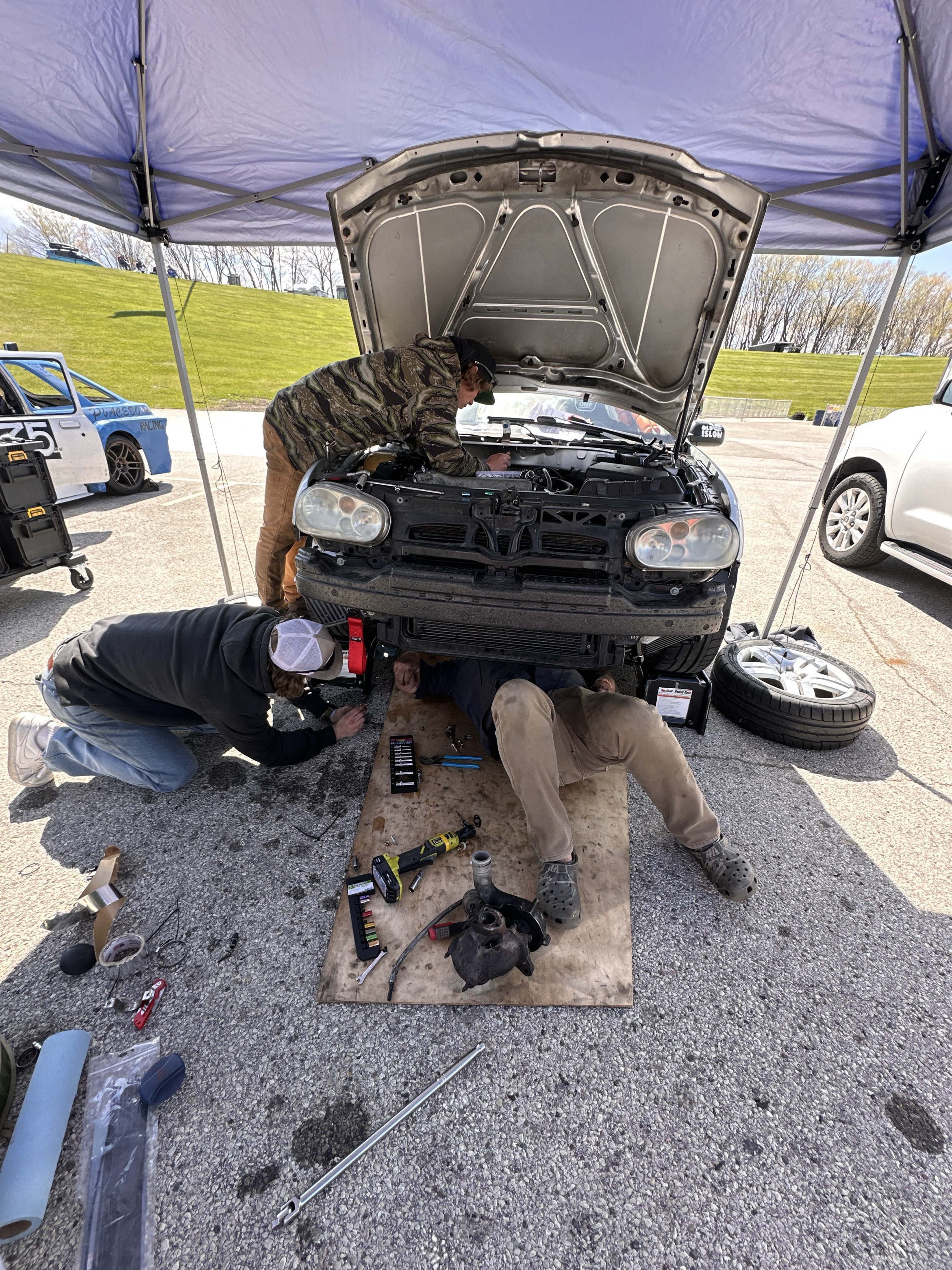 Crew working on turbo swap underneath the GTI