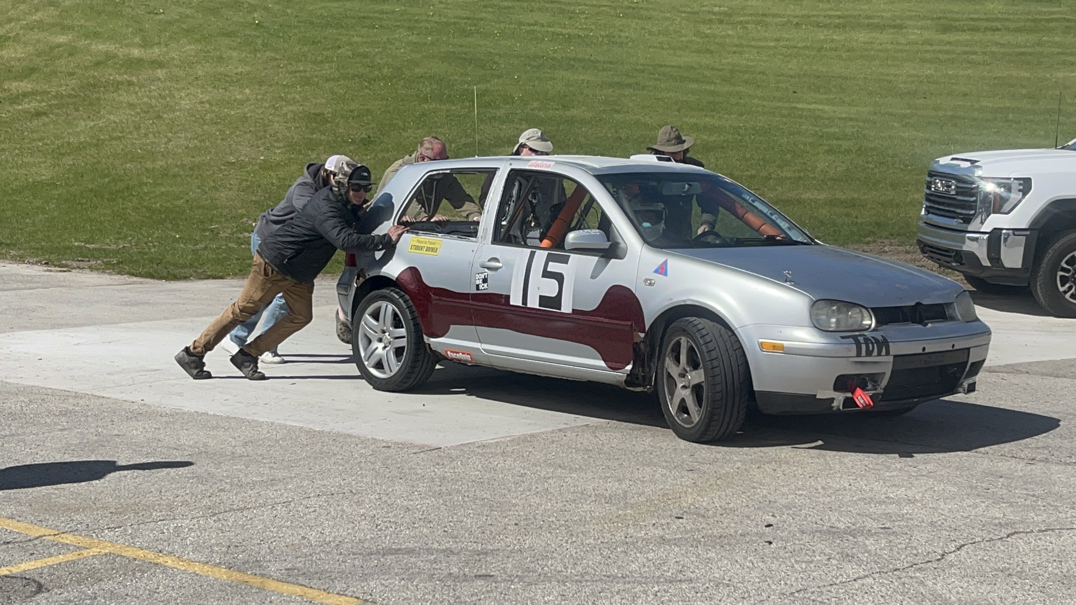 Crew pushing car 15 showing the silver and burgundy livery